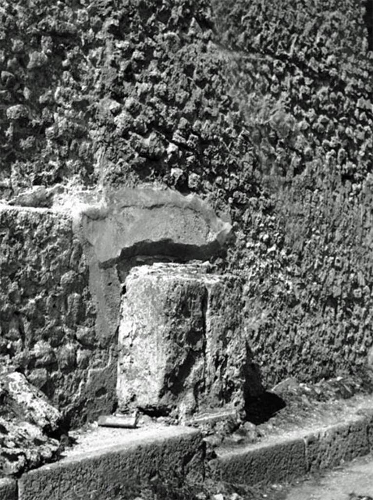 VI.12.6 Pompeii street altar. Old undated photograph of complete altar in situ. The vertical line in the stone appears to show there are two stone blocks making up the altar.