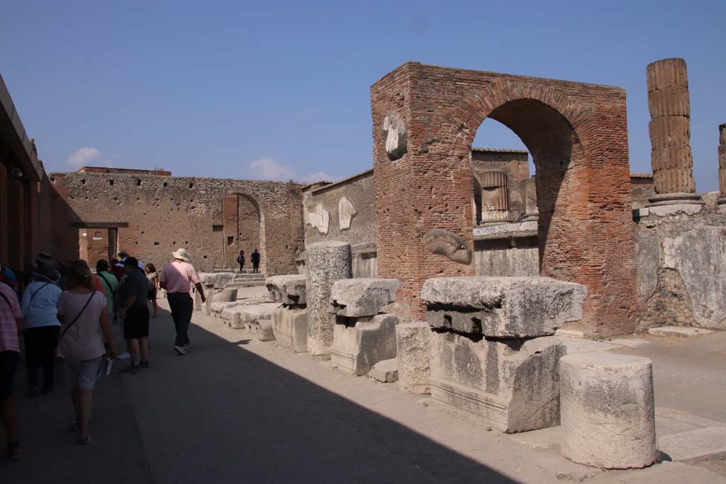 Arch of Augustus. September 2019. Looking north-east along the west side of the Temple of Jupiter. Photo courtesy of Klaus Heese. 