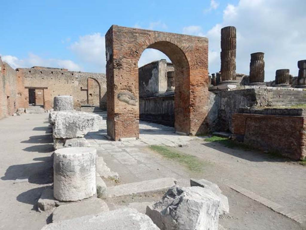 Arch of Augustus. May 2015. 
Looking north through the arch to the arched entrance leading into Vicolo dei Soprastanti, in the north-west corner of the Forum.
Photo courtesy of Buzz Ferebee.


