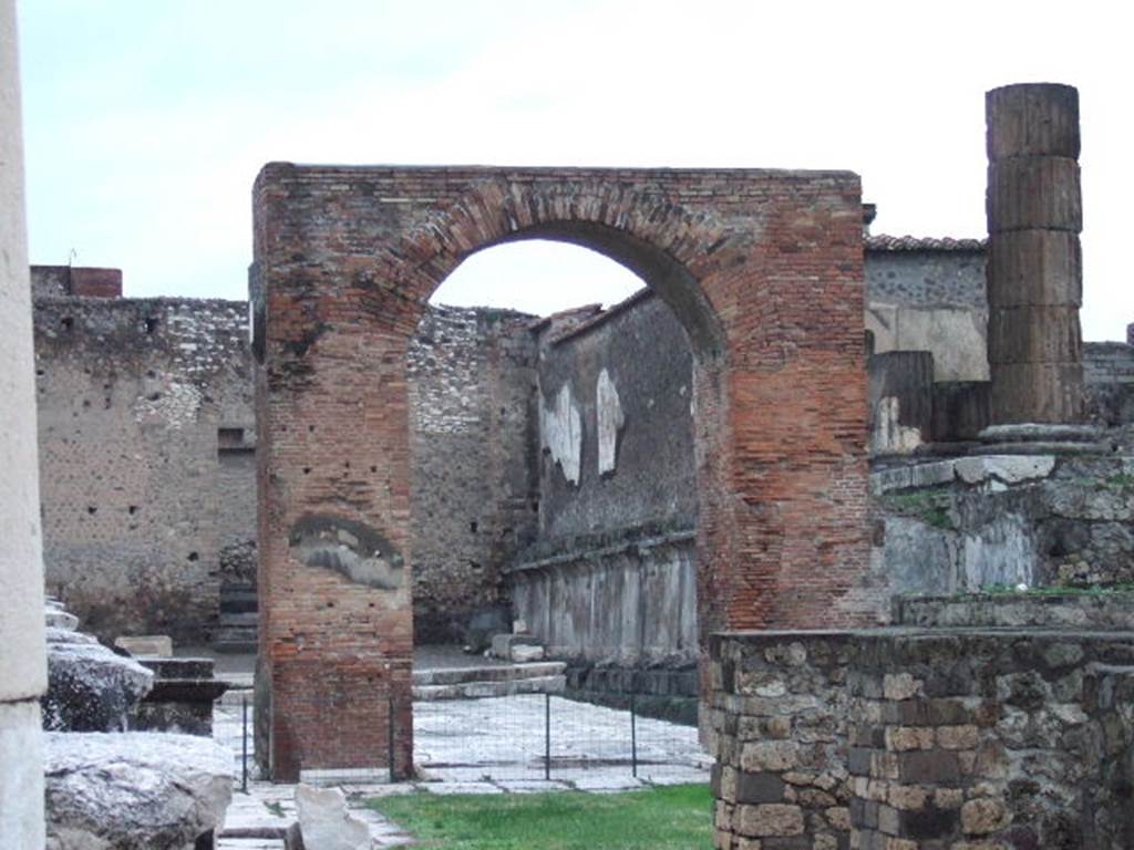 Arch of Augustus. December 2005. Looking north along west side of Temple of Jupiter.