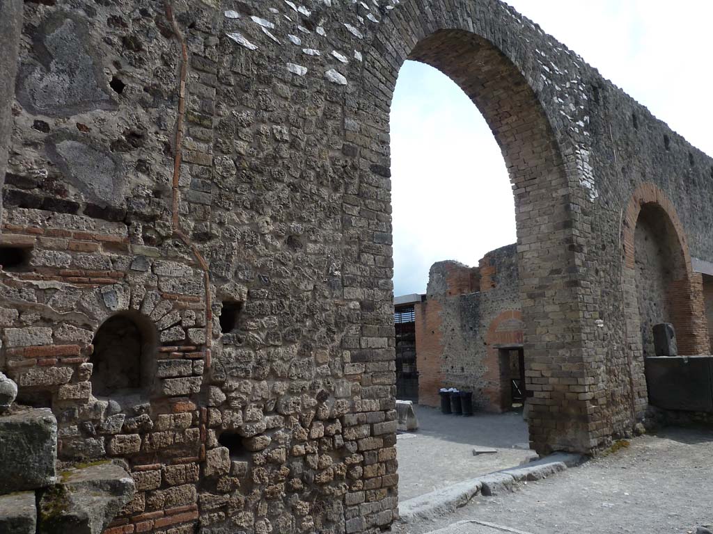 Arched entrance in north-west corner of Forum. May 2010. Looking south through arch towards the Arch of Augustus.
