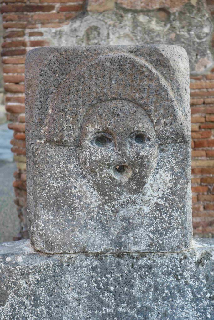 Fountain outside I.4.15 on Via Stabiana. 
December 2018. Fountain head with relief of comedy mask. Photo courtesy of Aude Durand.

