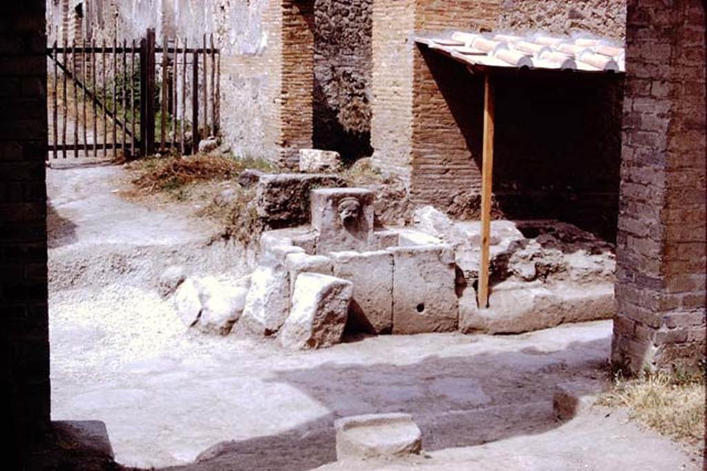 Fountain at 1.13.10.  Pompeii. 1972. Looking west across Via di Nocera. Photo by Stanley A. Jashemski. 
Source: The Wilhelmina and Stanley A. Jashemski archive in the University of Maryland Library, Special Collections (See collection page) and made available under the Creative Commons Attribution-Non Commercial License v.4. See Licence and use details. J72f0397
