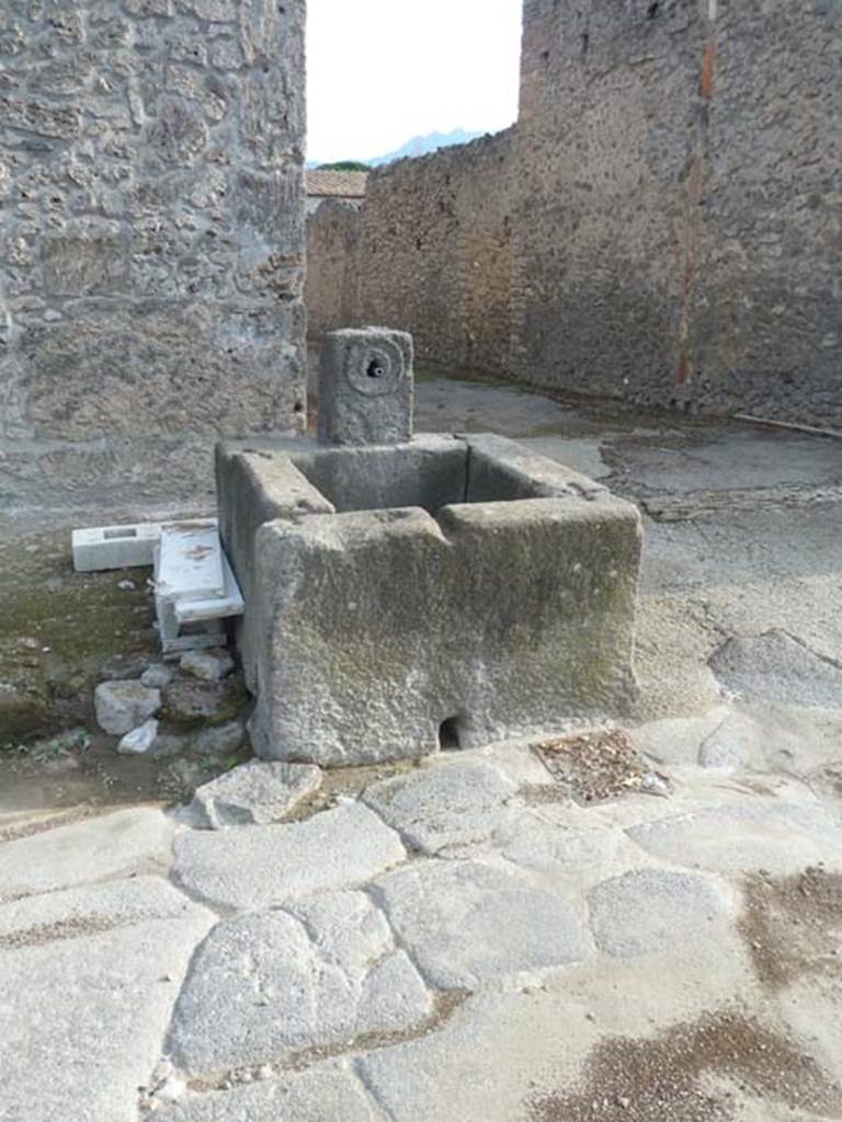 Fountain outside I.16.4. December 2018. Via di Castricio, south side (on left) with entrance doorway to I.16.4.
Junction with unnamed vicolo between I.16 and I.17, on right. Photo courtesy of Aude Durand.

