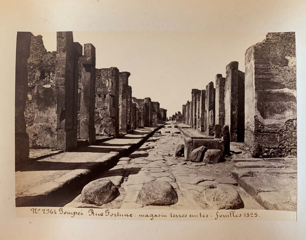 Fountain outside VI.13.7. Via della Fortuna, Pompeii. Photograph by M. Amodio, from an album dated April 1878.
Looking west towards fountain between VII.4 and VI.13, and junction with Vicolo dei Vettii, on the right. 
Photo courtesy of Rick Bauer.
