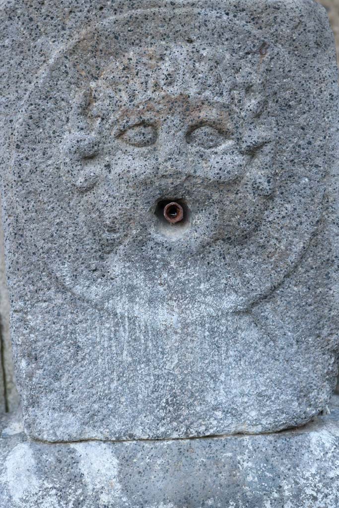 Fountain outside VIII.7.30. December 2018. 
Relief of medallion with Triton on pilaster. Photo courtesy of Aude Durand.

