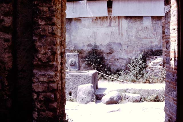 Fountain at IX.11.1 and street altar, Pompeii, 1980. Looking north across Via dell’Abbondanza. Photo by Stanley A. Jashemski.   
Source: The Wilhelmina and Stanley A. Jashemski archive in the University of Maryland Library, Special Collections (See collection page) and made available under the Creative Commons Attribution-Non Commercial License v.4. See Licence and use details. J80f0225
