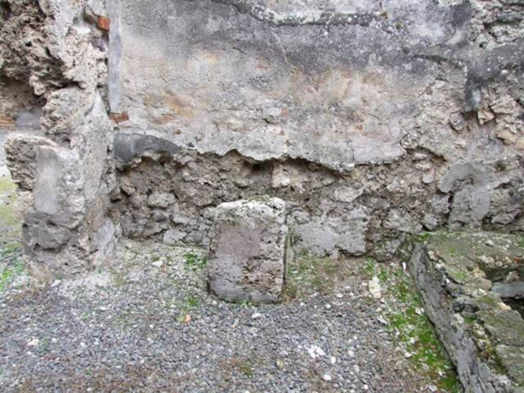 IX.1.12 Pompeii. December 2007. South wall and south-east corner near doorway of kitchen. Masonry altar.
According to Boyce, the lararium painting was done on a white background.
When he wrote his book in 1937, he said that on the right and left, the legs of the figures of the Lares were preserved.
In the middle was the lower part of Venus Pompeiana wearing a yellow chiton and blue mantle.
In her left hand she held a sceptre, and her right rested on a rudder.
At her side was a cupid who seemed to be leaning forward to touch the garment of the goddess.
Below this, the two serpents confronted at a painted altar.
On the floor below the painting a masonry altar stands against the wall.
See Boyce G. K., 1937. Corpus of the Lararia of Pompeii. Rome: MAAR 14. (p.79)  
See Giacobello, F., 2008. Larari Pompeiani: Iconografia e culto dei Lari in ambito domestico. Milano: LED Edizioni. (p.204, no.96).

Remains of the altar and household shrine recorded by Helbig: Kitchen: Venus Pompeiana and Gods, 66?  
See Helbig, W., 1868. Wandgemälde der vom Vesuv verschütteten Städte Campaniens. Leipzig: Breitkopf und Härtel. (66).
See Pappalardo, U., 2001. La Descrizione di Pompei per Giuseppe Fiorelli (1875). Napoli: Massa Editore. (p.138)
See Fiorelli, G. (1875). Descrizione di Pompei, (p.370)



