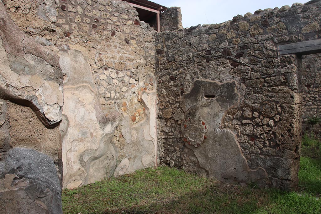 IX.7.19 Pompeii. October 2024. Looking north-east in ala c towards east wall, on right. Photo courtesy of Klaus Heese.
According to Boyce, on the east wall of the left ala, a fragment of a lararium painting was seen at the time of excavation.
The fragment represented a single serpent moving amongst foliage.
See Boyce G. K., 1937. Corpus of the Lararia of Pompeii. Rome: MAAR 14. (p.88, no.437)  
See Fröhlich, T., 1991. Lararien und Fassadenbilder in den Vesuvstädten. Mainz: von Zabern. (p.112).
