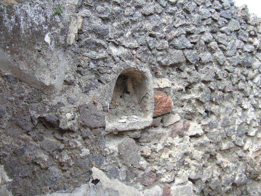 IX.9.6 Pompeii. May 2006. Niche in west wall of cubiculum.
According to Boyce – 
this niche (h.0.45, w.0.41, d.0.18, h. above floor 1.27) had walls coated with white stucco decorated with green, yellow and violet spots, probably representing flowers.
See Boyce G. K., 1937. Corpus of the Lararia of Pompeii. Rome: MAAR 14. (p. 91 no. 457) 

