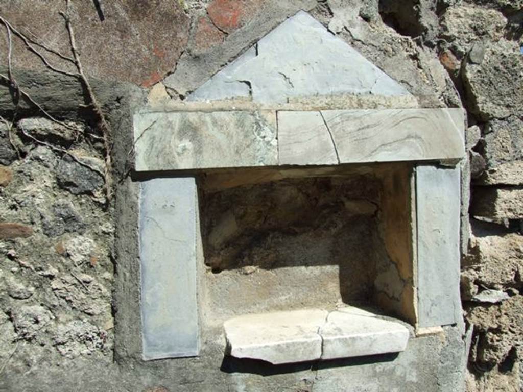 I.2.17 Pompeii. March 2009. Lararium niche of coloured marble, in east wall of fauces. According to Boyce, the walls, projecting floor and aedicula façade of this rectangular niche are all of greyish marble. In the floor were three holes for the bases of statuettes. See Boyce G. K., 1937. Corpus of the Lararia of Pompeii. Rome: MAAR 14.  (p.22 no.9, pl.7,2)
