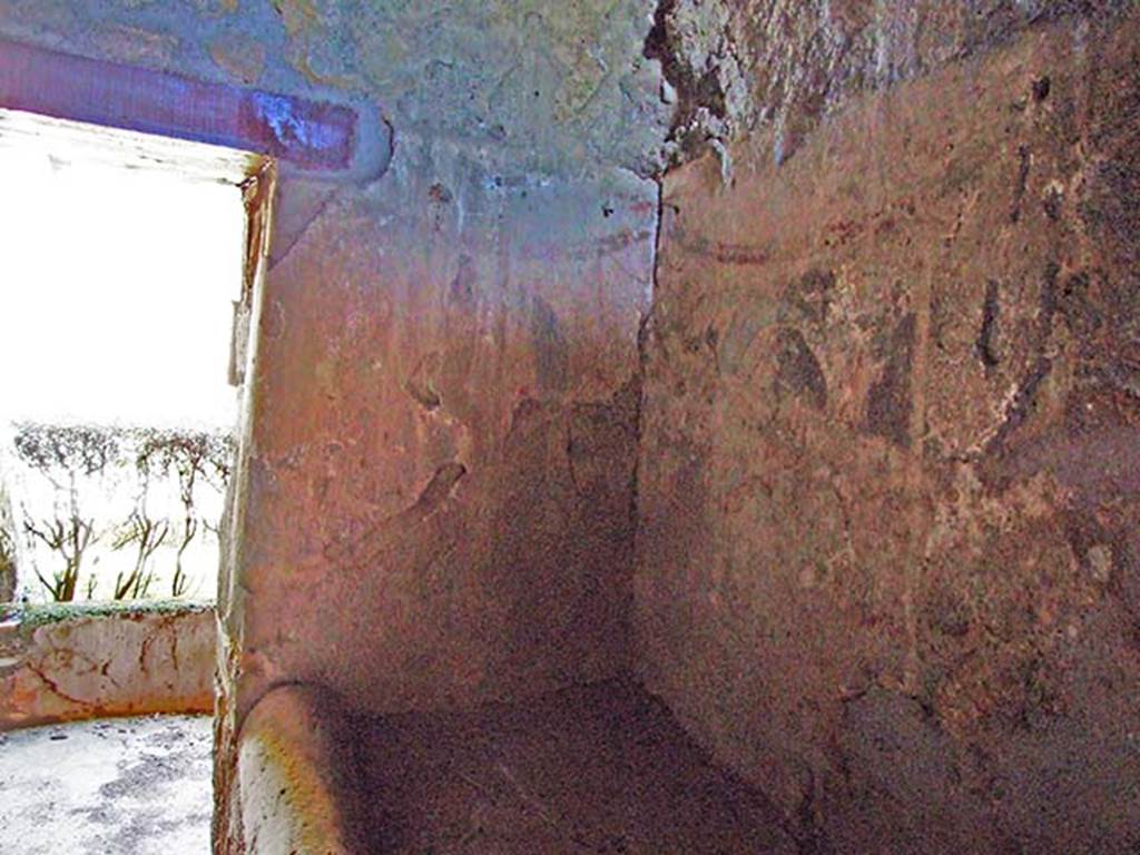 I.12.11 Pompeii. March 2009. Kitchen, east wall and south-east corner, lararium painting with remains of painted garlands.  