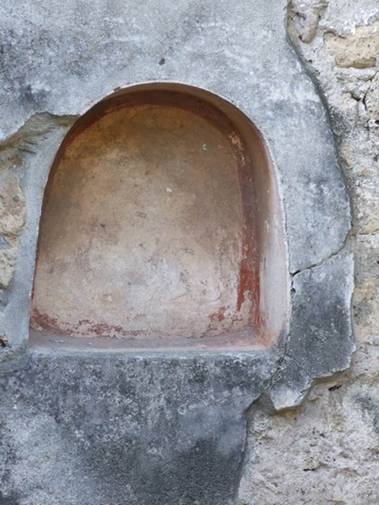 V.2.4 Pompeii. December 2007. Niche on west wall of peristyle. According to Boyce, in the west wall of the peristyle, in the centre of the space beneath the front portico, was an arched niche. It was coated with white stucco like the walls of the room, except that the floor and the corners were red.
See Boyce G. K., 1937. Corpus of the Lararia of Pompeii. Rome: MAAR 14.  (p.34, no.87)
