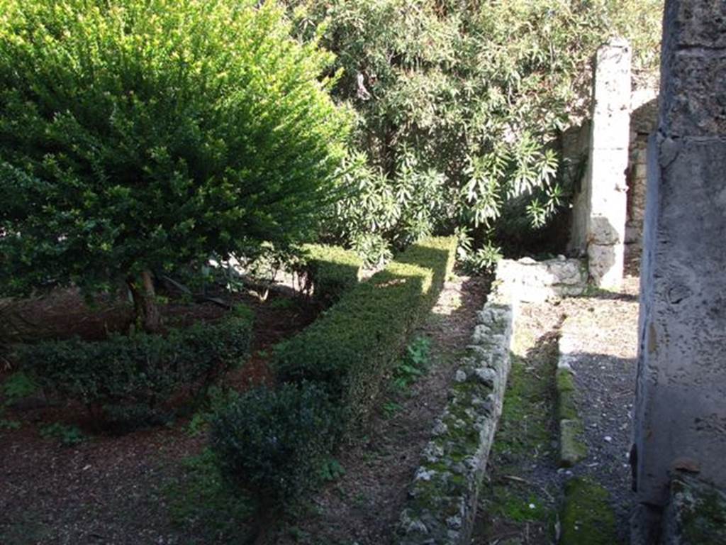 V.2.4 Pompeii. December 2007. Room 13, peristyle drainage channel, looking east towards south-east corner. According to Boyce, in the south-east corner of the garden were painted the two familiar serpents. One on each wall, one on the south and one on the east wall. The altar was painted between them in the corner of the wall. The serpents were brown and yellow on a white ground.
See Boyce G. K., 1937. Corpus of the Lararia of Pompeii. Rome: MAAR 14.  (p.34, no.88)
