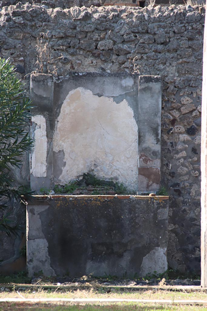 VI.7.20 Pompeii. October 2022.
Looking west to altar in peristyle. Photo courtesy of Klaus Heese. 
According to Boyce –
Against the west wall of the pseudo-peristyle stands a huge aedicula.
See Boyce G. K., 1937. Corpus of the Lararia of Pompeii. Rome: MAAR 14, (p.48, no.166).
See Giacobello, F., 2008. Larari Pompeiani: Iconografia e culto dei Lari in ambito domestico. Milano: LED Edizioni, (p.270 no.V45)

