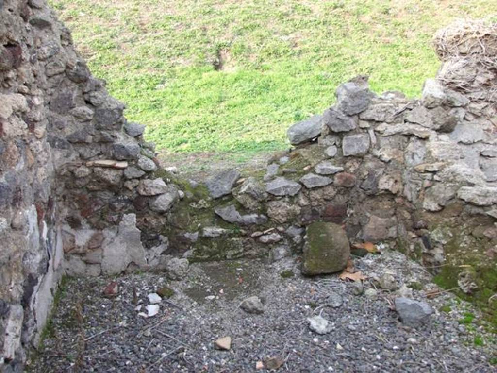 VI.9.14 Pompeii. December 2007. Room 28, north wall of kitchen. In this area was found a badly preserved hearth, and there was formerly a lararium in the room. According to Boyce, Avellino reported a lararium painting in the kitchen – il solito dipinto de’ Lari. He quoted the reference Bull. Arch. Nap., i, 1843, 70 
See Boyce G. K., 1937. Corpus of the Lararia of Pompeii. Rome: MAAR 14. (p.49, no.173) 
