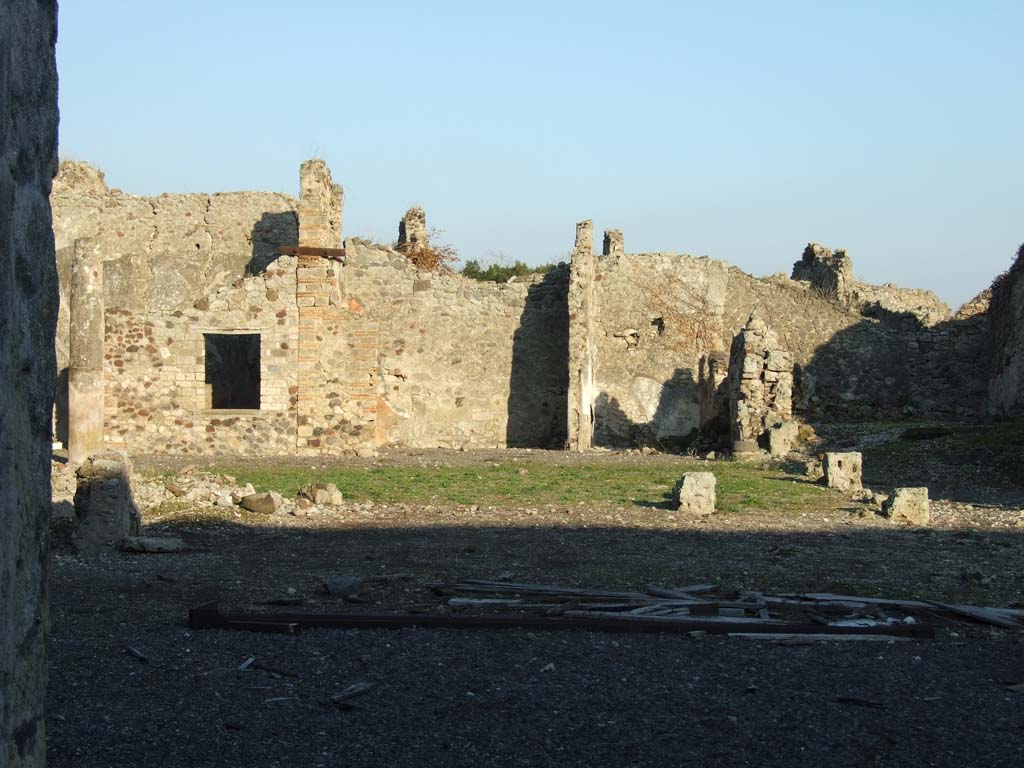 VI.14.38 Pompeii. December 2007. Site of tablinum, and peristyle, looking east to rear rooms.
Jashemski reported that the middle panel of the right (south) wall of the tablinum, instead of having the usual large painting, was plain yellow and contained a small garden scene.
This was reported but not described by Mau.
The left (north) wall was almost completely destroyed at the time of the eruption.
See Jashemski, W. F., 1993. The Gardens of Pompeii, Volume II: Appendices. New York: Caratzas. (p.398, with ref: Mau, BdI (1878), p.115)

According to Jashemski, the peristyle garden at the rear of the tablinum would have been visible from the entrance.
The tablinum would have been completely open on both its east and west ends.
The garden was enclosed on the north, west and south sides by a portico, supported at the time of the eruption by nine columns.
There was a cistern opening without a puteal on both the north and south sides between the two west columns.
In the garden were two marble table supports, and a monopodium without the basin which it probably supported.
In the south-west corner of the peristyle were the ruins of an arched niche.
See Jashemski, W. F., 1993. The Gardens of Pompeii, Volume II: Appendices. New York: Caratzas. (p.150-51)

According to Boyce, in the south-west corner of the peristyle were the ruins of an arched niche, with heavy projecting floor.
See Boyce G. K., 1937. Corpus of the Lararia of Pompeii. Rome: MAAR 14. (p.53, no.205) 
See Giacobello, F., 2008. Larari Pompeiani: Iconografia e culto dei Lari in ambito domestico. Milano: LED Edizioni. (p.275)
