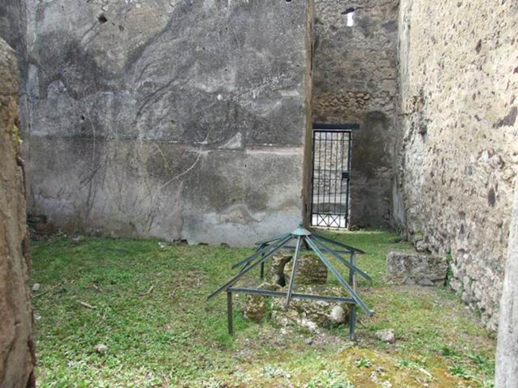 VI.16.29 Pompeii. March 2009. Room O, looking west across to fauces P of entrance VI.16.30. According to NdS, room O was quite spacious and had a rough cocciopesto floor and bare walls, with the usual brick plinth. On the north wall was the base  stone of a wooden staircase. In the north-east corner was the cistern mouth. On the extreme right of the west wall was painted on the plinth, from the right to the left, a serpent agatodemone, which approached towards an altar through plants. Found in the soil of this house on the 29th August 1904, but without a precise indication of place, was the upper part of an altar of red marble (m.0.08 x 0.065). See Notizie degli Scavi di Antichità, 1908, (p.284). According to Boyce, in the room entered from the posticum of VI.16.30 was a lararium. It was on the white ground of the dado of the west wall. A single yellow serpent was painted, advancing to the left towards an altar furnished with offerings. In the background were plants. See Notizie degli Scavi di Antichità, 1908, (p.284). See Boyce G. K., 1937. Corpus of the Lararia of Pompeii. Rome: MAAR 14. (p. 59, no 227).
.