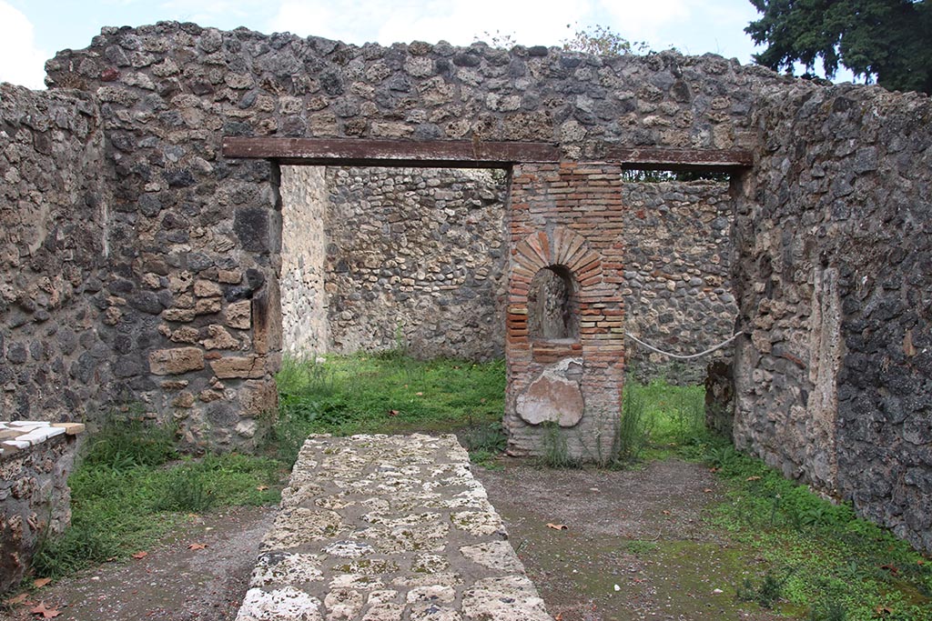 I.1.2 Pompeii, October 2024. 
Looking east across bar/selling room with counters. At the rear are entrances to two rear rooms. Photo courtesy of Klaus Heese.
