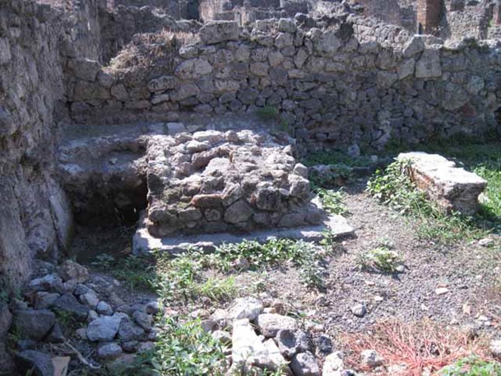 I.1.8 Pompeii. September 2010. Photo courtesy of Drew Baker.
West wall of rear yard, with feature in south-west corner, possibly a masonry watering trough. Looking west. See Mau, A., 1907, translated by Kelsey, F. W., Pompeii: Its Life and Art. New York: Macmillan. (p. 401-2).
