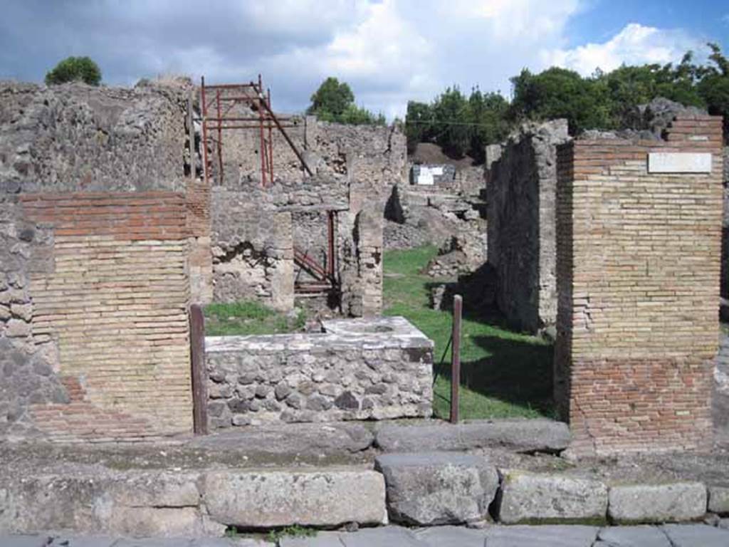 1.2.1 Pompeii. September 2010. Entrance looking east, from Via Stabiana. The side/rear doorway can be seen at I.2.32, on the right. Photo courtesy of Drew Baker.

Warscher described this as –
“I.2.1 una ampia caupona a due porta, poiché risponde anche nel vico a mezzogiorno col vano segnato dal No.32”.
See Warscher T., 1935. Codex Topographicus Pompeianus: Regio I.2.(after photo no.1). Rome:DAIR, whose  copyright it remains.
