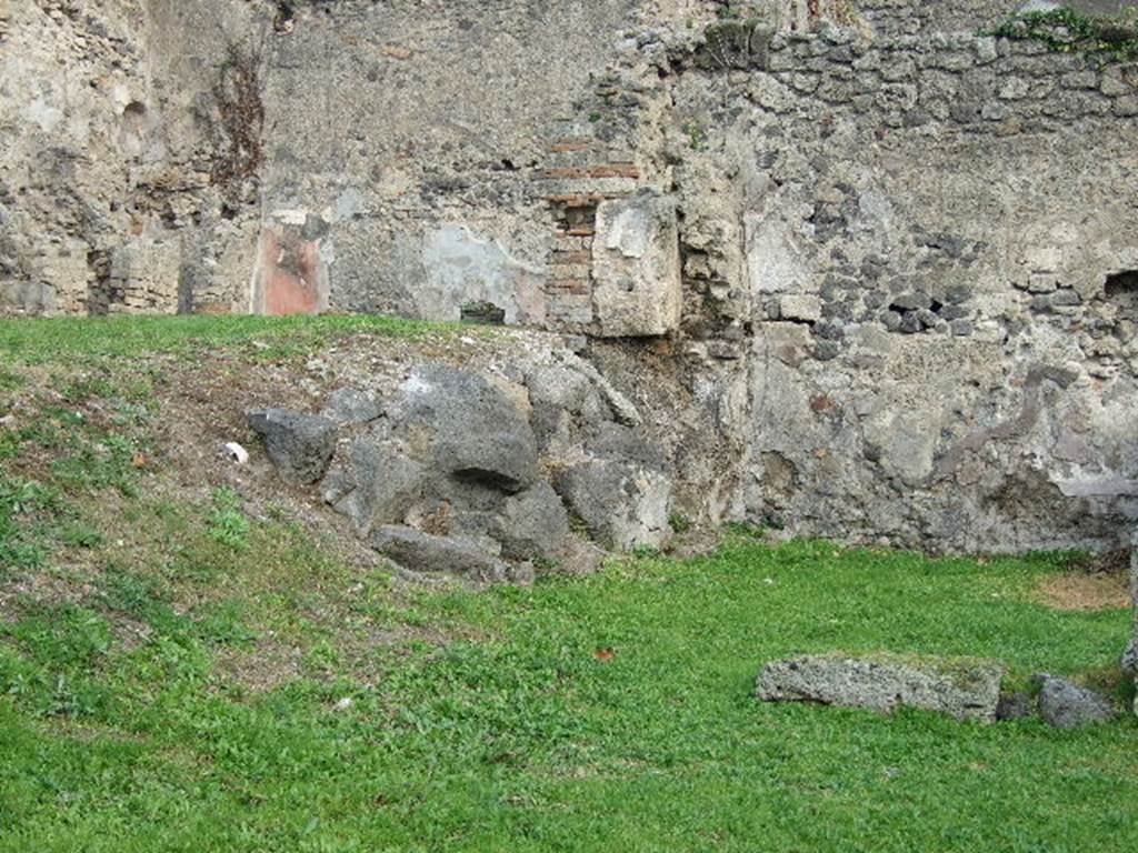 I.2.3 Pompeii. December 2006. North and east side of Triclinium on lower level, with a large block of Vesuvian lava from pre-historic times. To the north on the higher level are the remains of house number I.2.6. This area was bombed in September 1943. The impluvium was destroyed, and the three rooms to the north of the atrium, together with the north wall separating the two houses were demolished. See Van der Poel, H. B., 1986. Corpus Topographicum Pompeianum, Part IIIA. Austin: University of Texas. (p.4) See Garcia y Garcia, L., 2006. Danni di guerra a Pompei. Rome: L’Erma di Bretschneider. (p.37-38)
