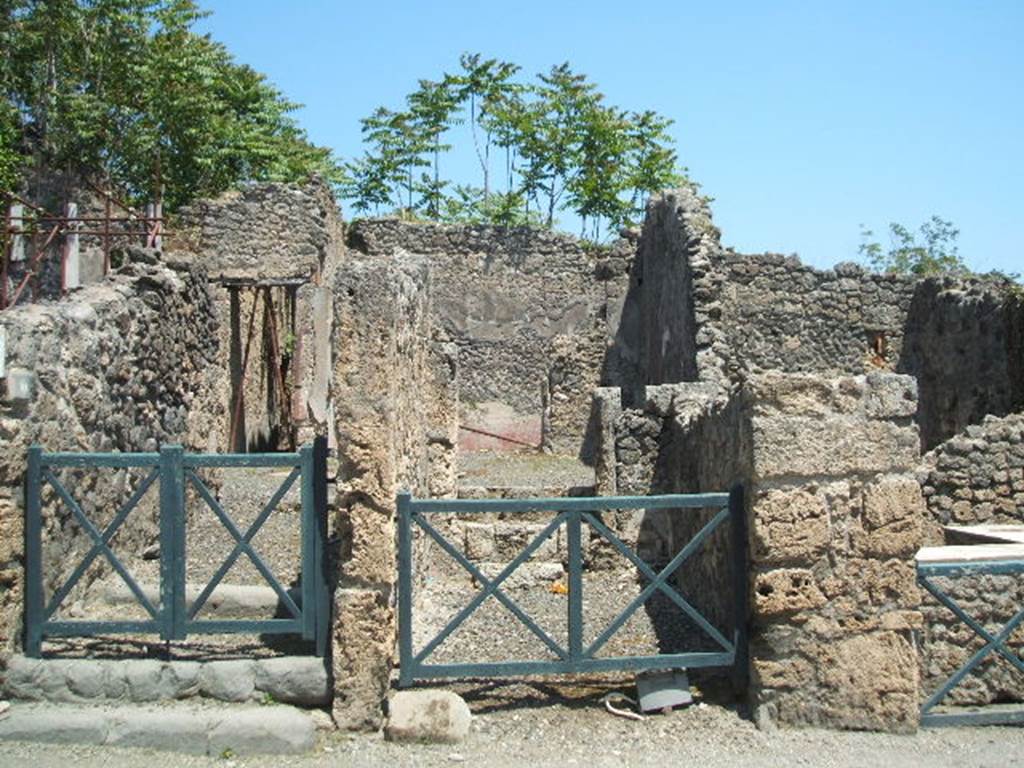 I.2.10 Pompeii, on left. May 2005. Looking east from Via Stabiana towards entrances.  I.2.9, in centre. 