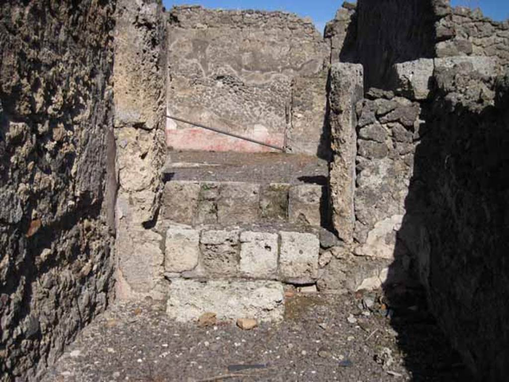 I.2.9 Pompeii. September 2010. East wall of shop, with steps leading up to atrium of I.2.10. Photo courtesy of Drew Baker.
