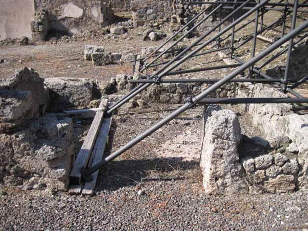 I.2.10 Pompeii. September 2010.  Looking north into doorway of remains of cubiculum, in north-west corner of atrium. At the rear is I.2.11/12/13/14. Photo courtesy of Drew Baker.
