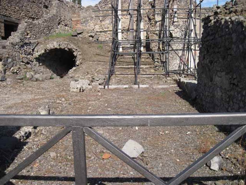 I.2.12 Pompeii. September 2010. Looking east from entrance. The lower remains of the north and east wall can be seen. In the north wall, on the left, was a doorway into the communicating bar-room. At the rear, in the east wall, was a doorway into the area with a wooden staircase to the upper floor and a passage leading to the latrine. Photo courtesy of Drew Baker.
