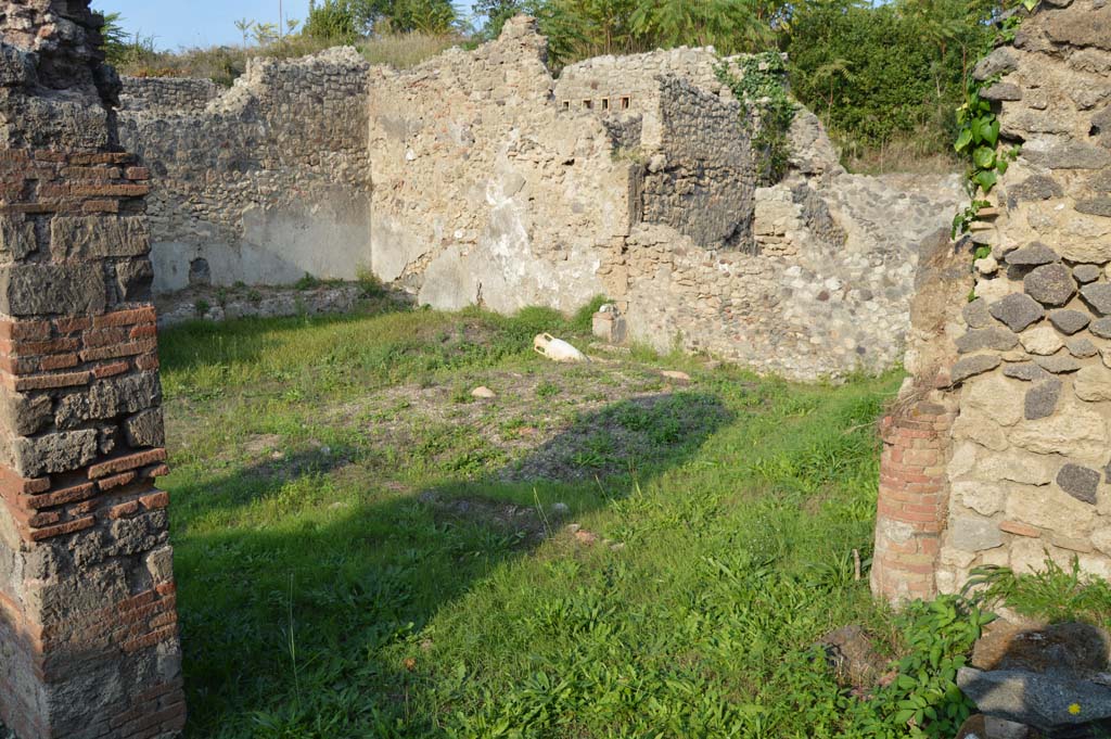 I.2.24 Pompeii. October 2017. 
Looking towards the north and east walls of the peristyle, with the solid base of the aedicula lararium against the east wall, centre right. 
Foto Taylor Lauritsen, ERC Grant 681269 DCOR.



