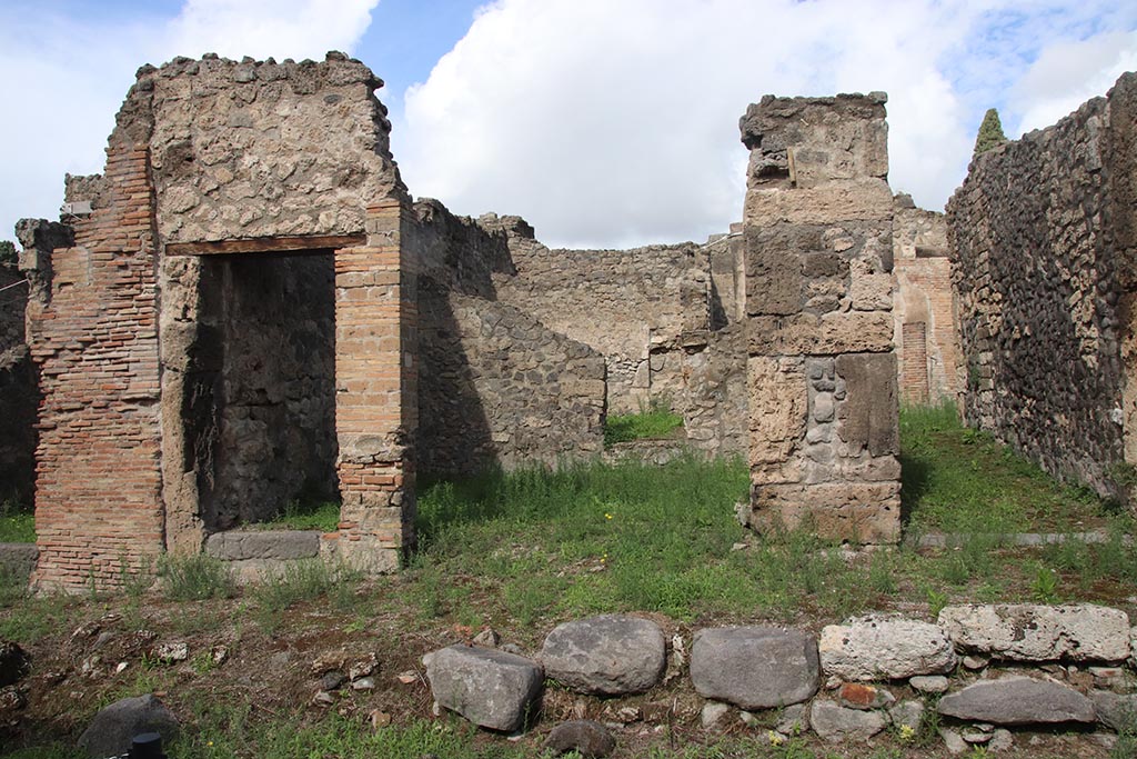 I.2.25 Pompeii, in centre. October 2024. 
Looking north towards entrances to I.2.26 on left, I.2.25 in centre, and I.2.24 on right. Photo courtesy of Klaus Heese.
