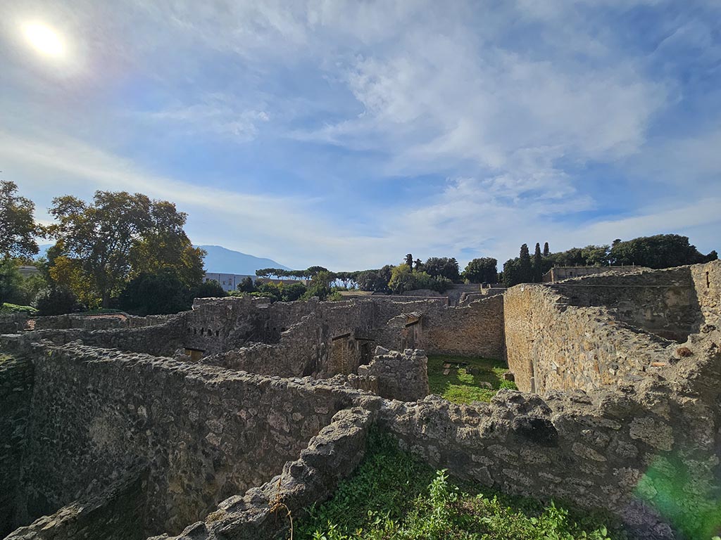 I.2.28 Pompeii. November 2024. 
Looking west along the north side, centre right, towards triclinium in peristyle garden area, photo taken from I.2.20. 
Photo courtesy of Annette Haug.
