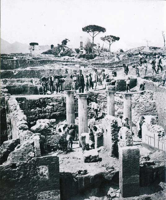 I.2.29-28 Pompeii. Old photo c.1870 showing thermopolium and house during excavation. Photo courtesy of Rick Bauer.

According to Fiorelli, on this doorway were two electoral recommendations. 
One in honour of Lucium Ceium Secundum, acclaimed many times in other places:
L. C. S. II . VIR . I . D.
and
POPIDIVM         AED .  ROG
                             POLYBIVS 
See Pappalardo, U., 2001. La Descrizione di Pompei per Giuseppe Fiorelli (1875). Napoli: Massa Editore. (p.38)

According to Della Corte, this bar was a dependence of the neighbouring house at I.2.28. He could not speculate who it belonged to. He thought it was lived in by a certain Polybius, as proved by the recommendation found to the east (right) of the entrance:
Polybius rog(at)  [CIL IV 3379]. See Della Corte, M., 1965.  Case ed Abitanti di Pompei. Napoli: Fausto Fiorentino. (p.275)

According to Epigraphik-Datenbank Clauss/Slaby (See www.manfredclauss.de) these read –

Popidium 
/ 
aed(ilem) rog(at) 
Polybius        [CIL IV 3379]

L(ucium) C(eium) S(ecundum) IIv(irum) i(ure) d(icundo)       [CIL IV 3380]
