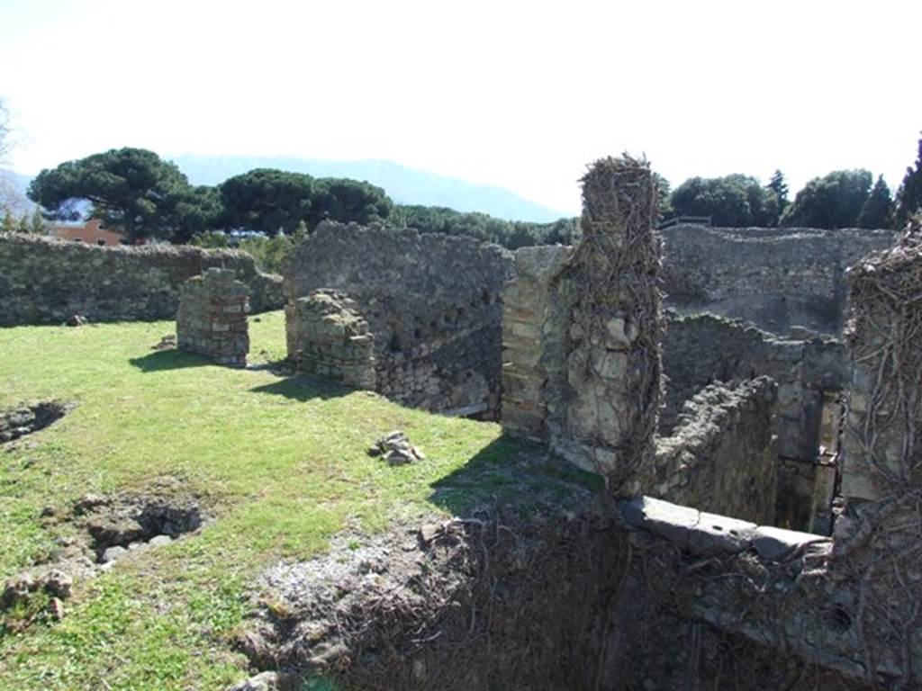 1.3.3 Pompeii. March 2009.  South-west corner of peristyle, with doorways to exedra/triclinium on left, and corridor and oecus, two rooms with collapsed floors.On the right can be seen the doorway leading to the steps to the lower floor.

