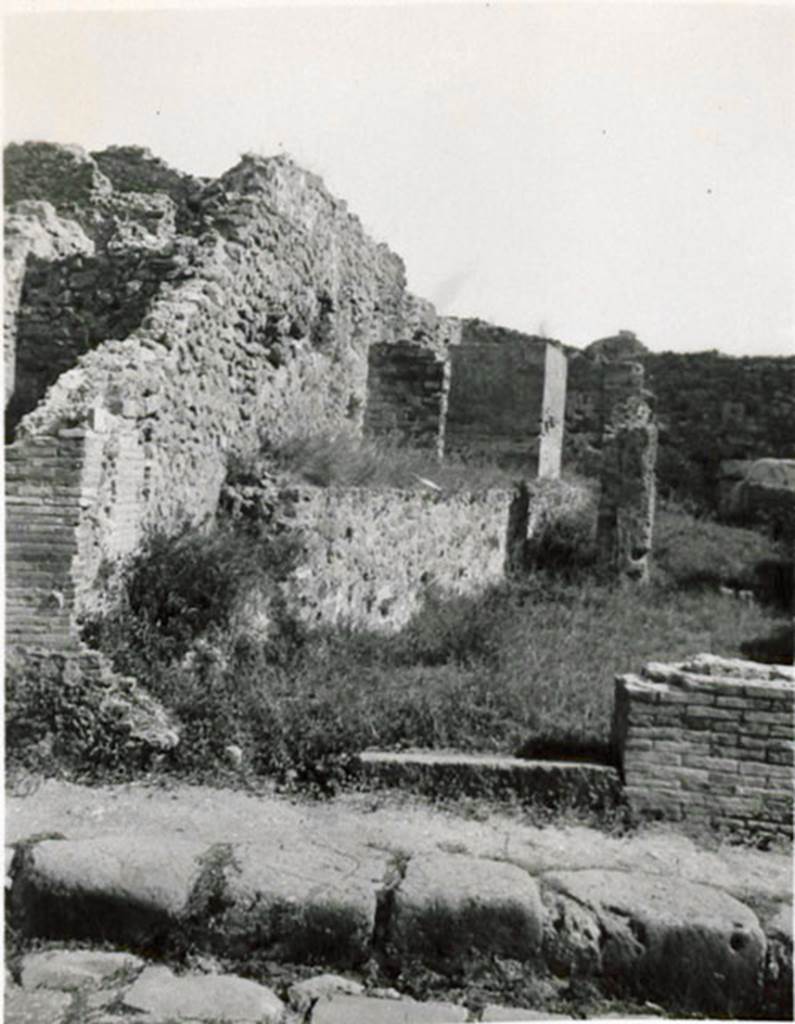 I.3.10 Pompeii. 1935 photograph taken by Tatiana Warscher, looking east towards entrance from Via Stabiana. 
See Warscher, T, 1935: Codex Topographicus Pompejanus, Regio I, 3: (no.26), Rome, DAIR, whose copyright it remains.  
According to Warcher, This was a workshop with other rooms, altered from the ancient configuration by the route of the Sarno canal built by Fontana: here one can see the remains of wash-tubs and furnaces that existed here before.
