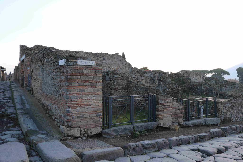 I.3.12 Pompeii, in centre. December 2018. 
Looking east towards entrance doorway on corner of Via Stabiana and its junction with Vicolo del Menandro. Photo courtesy of Aude Durand.
