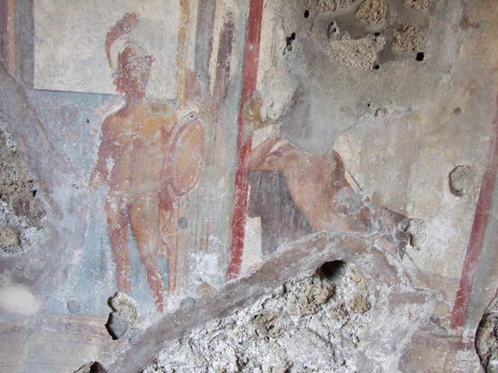 I.3.25 Pompeii. December 2006. Oecus, east wall. Detail of wall painting of Apollo in judgement. His right arm rests on a chair and is supporting his head in thought. A warrior to the left symbolises beauty.