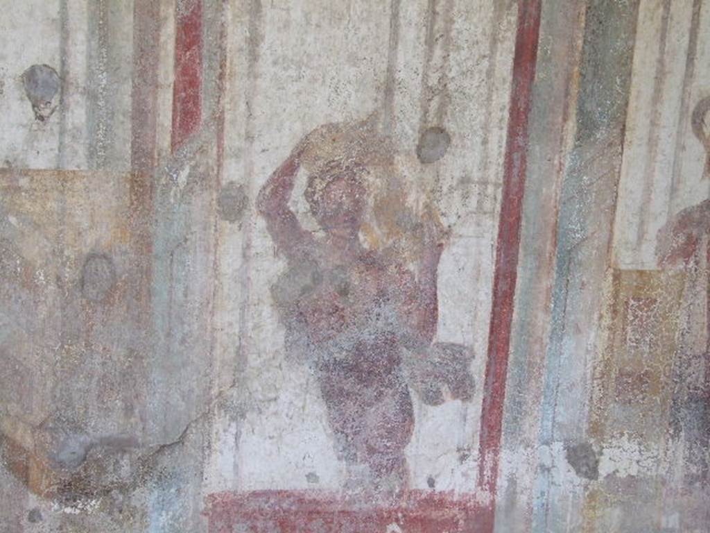 I.3.25 Pompeii. December 2006. South wall, with detail of wall painting of figure carrying a vase. 