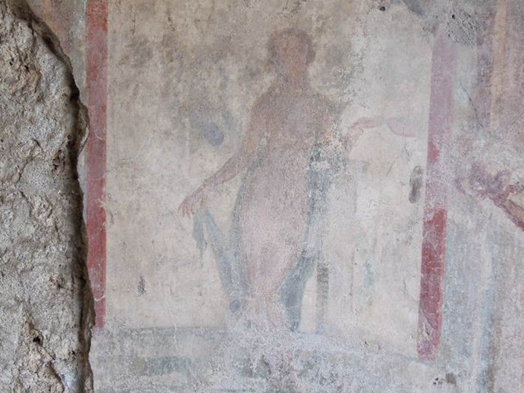 I.3.25 Pompeii. December 2006. Detail of wall painting on west wall. Aphrodite leaning on a pillar, with left leg over the right leg holding the end of her robe with her right hand.