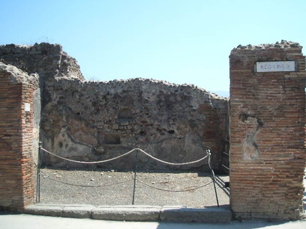 I.4.16 Pompeii. May 2005.  Two niches on south wall. According to Boyce, either or both of these could have been lararia.  The upper niche was arched and had its walls coated with red stucco. The lower rectangular niche had a back wall which curved from back to front. Its walls were coated with white stucco decorated with painted red dots, to represent flowers.
See Boyce G. K., 1937. Corpus of the Lararia of Pompeii. Rome: MAAR 14. (p.25) 
