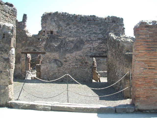 I.4.17 Pompeii. December 2007. South wall with doorway to I.4.12, on left, and door to I.4.13, on right.