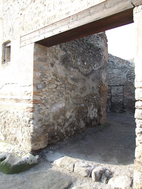 I.4.28 Pompeii. December 2007. Room 3, on west side of atrium. The doorway on the left leads to room 4, and the blocked doorway connecting to I.4.25 is on the right.
