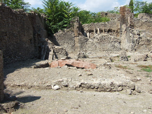I.5.2 Pompeii. July 2008. Looking west to south-west corner and west wall of peristyle area, showing small room with latrine.  Photo courtesy of Barry Hobson.

