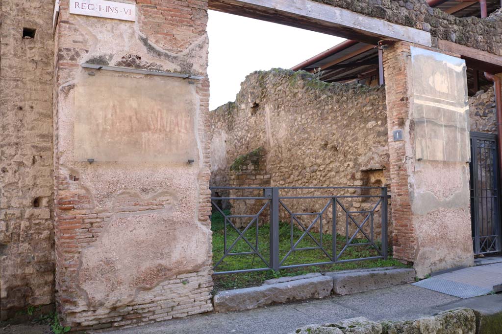 I.6.1 Pompeii. December 2018. Entrance doorway with graffiti on either side. Photo courtesy of Aude Durand.