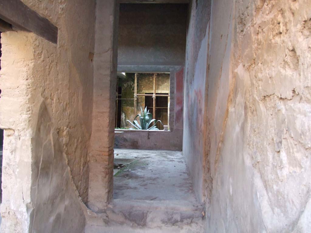 I.7.2 Pompeii. September 2019. Looking south.
On the left is the doorway connecting to the entrance corridor of I.7.3.
On the right, looking south through site of staircase, through a room that would have been under the stairs, into atrium of I.7.3.


