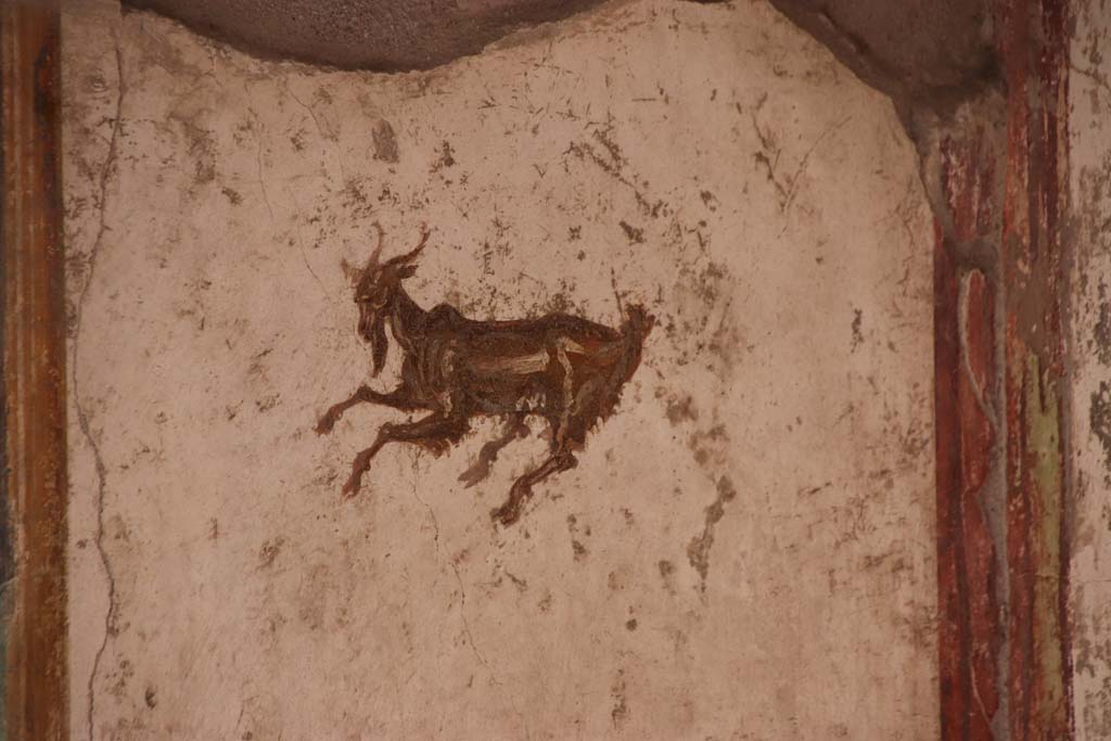 I.7.11 Pompeii. September 2021. Painted decoration in centre of east panel on north wall. Photo courtesy of Klaus Heese.