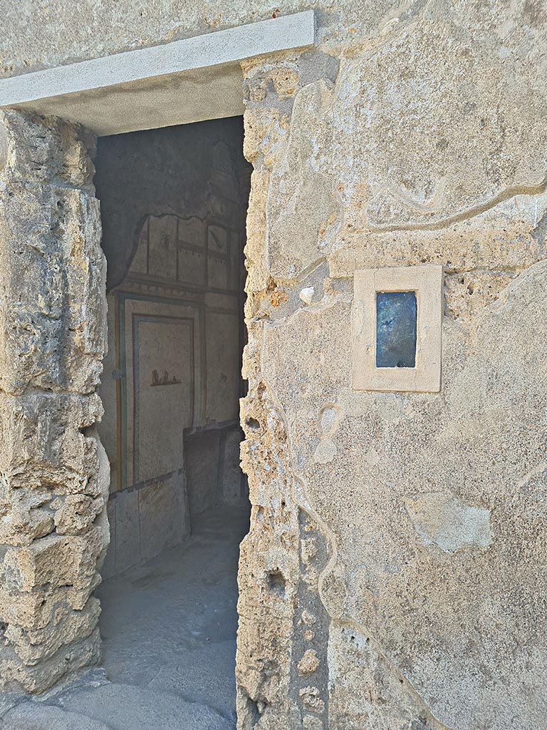 I.7.11 Pompeii. September 2024. 
Looking east through doorway to cubiculum to east of atrium, and on south side of entrance at I.7.11. 
Photo courtesy of Giuseppe Ciaramella.
