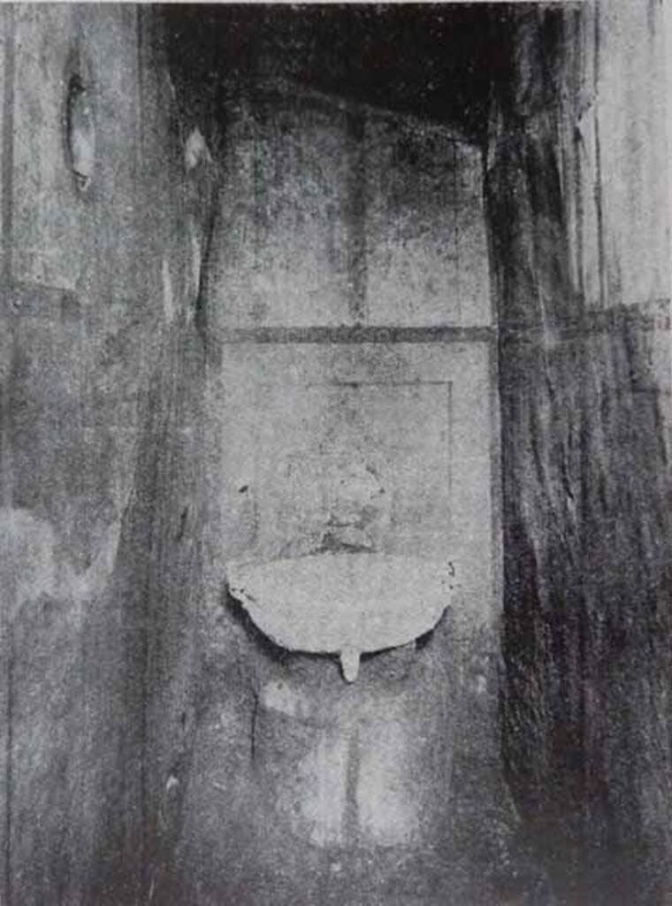 I.7.11 Pompeii. Old undated photograph showing small room with bronze basin, when first excavated.
