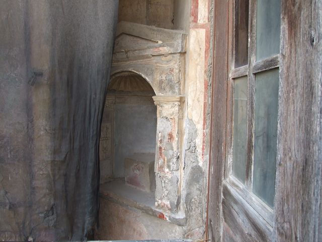 I.7.12 Pompeii. West wall of north portico, showing arched niche when first excavated.